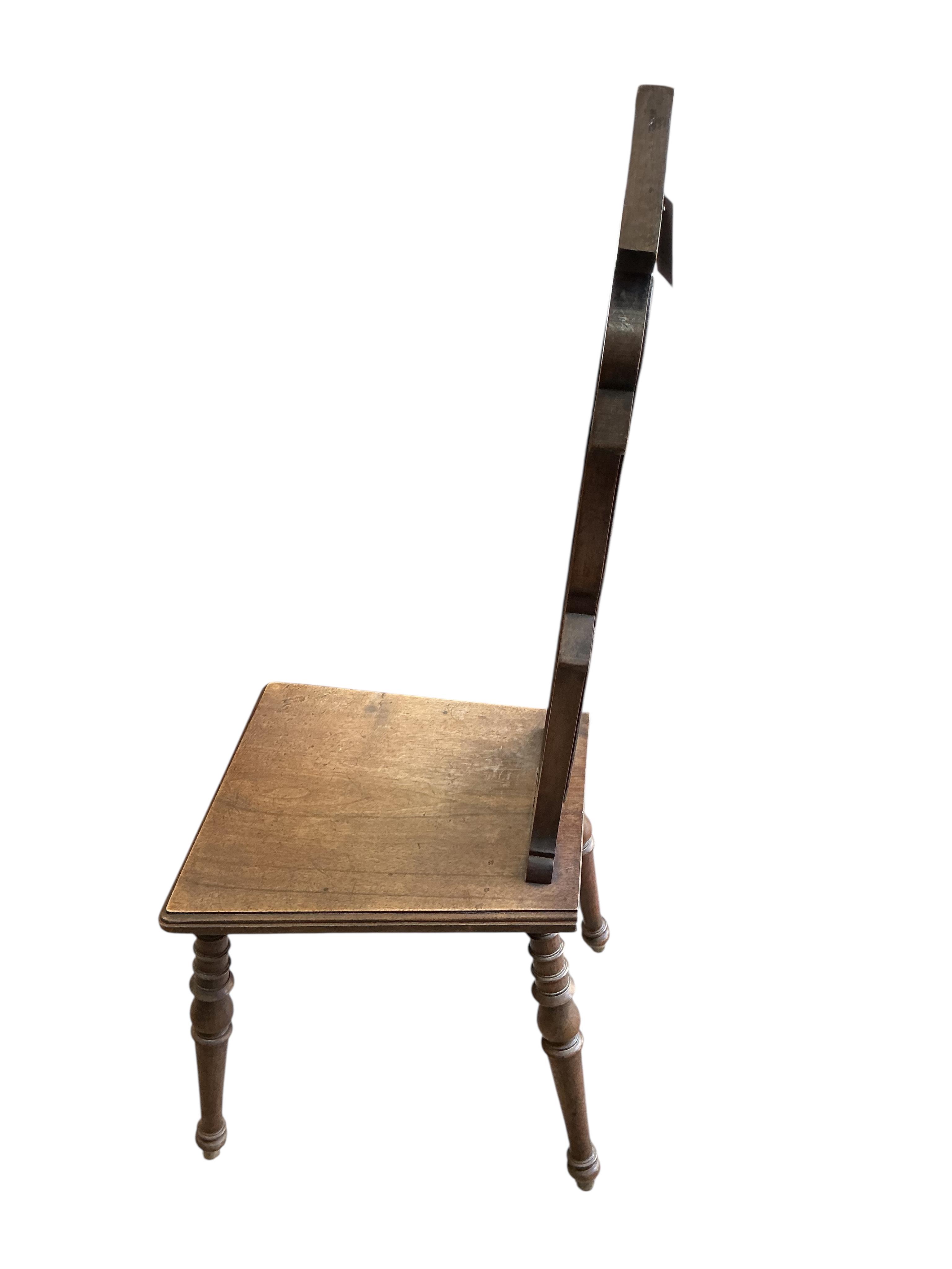A pair of early 20th century French carved walnut hall chairs, width 36cm, depth 40cm, height 108cm